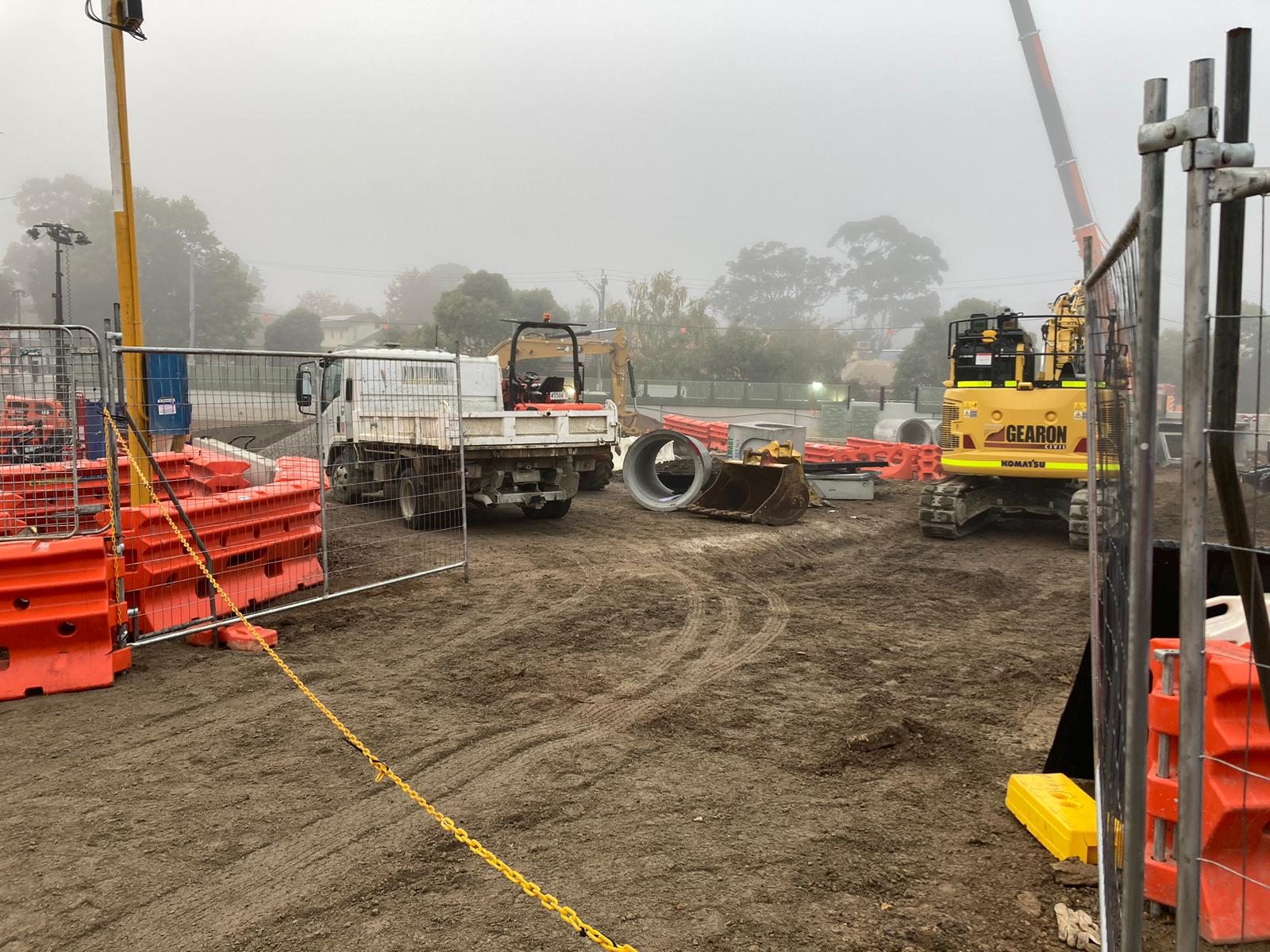 Civil work area with plant, temporary barriers and access controls
